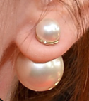 A pearl bubble earring shown with the large pearl to the back of the ear and the smaller pearl to the front.