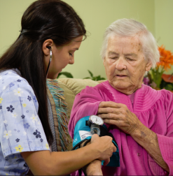 Homecare nurse taking patient's blood pressure